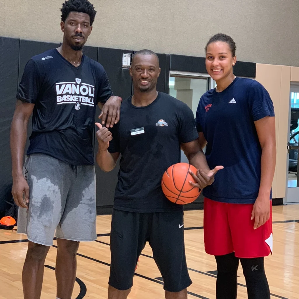 Coach Emmanuel with professional basketball players he has trained