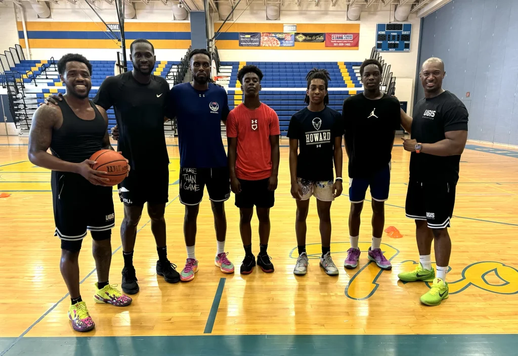With a group of athletes in a gym