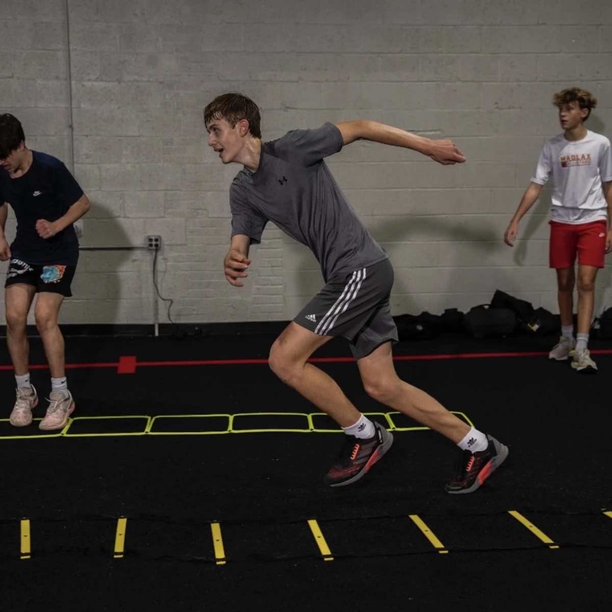 Athlete performing an agility ladder sprint during Performance/SAQ training