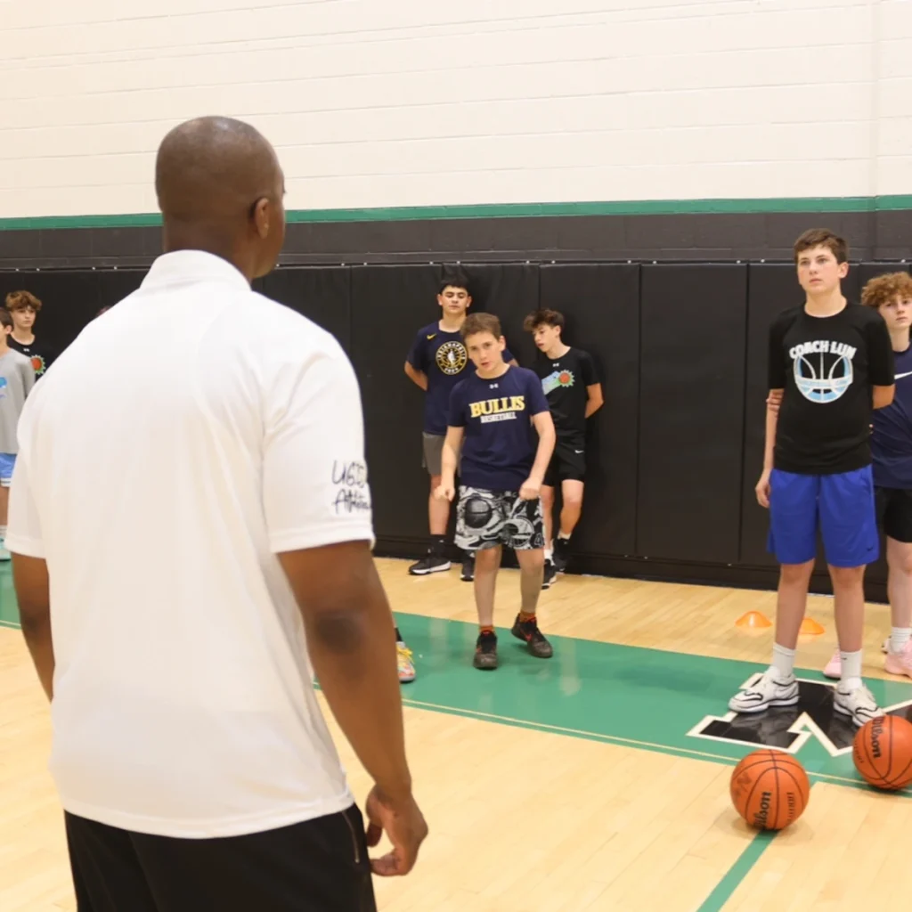 Coach Emmanuel coaching a group of young athletes